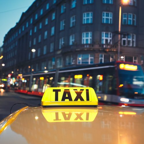 taxi-car-and-tram-of-public-transportation-on-the-city-street-at-night.jpg
